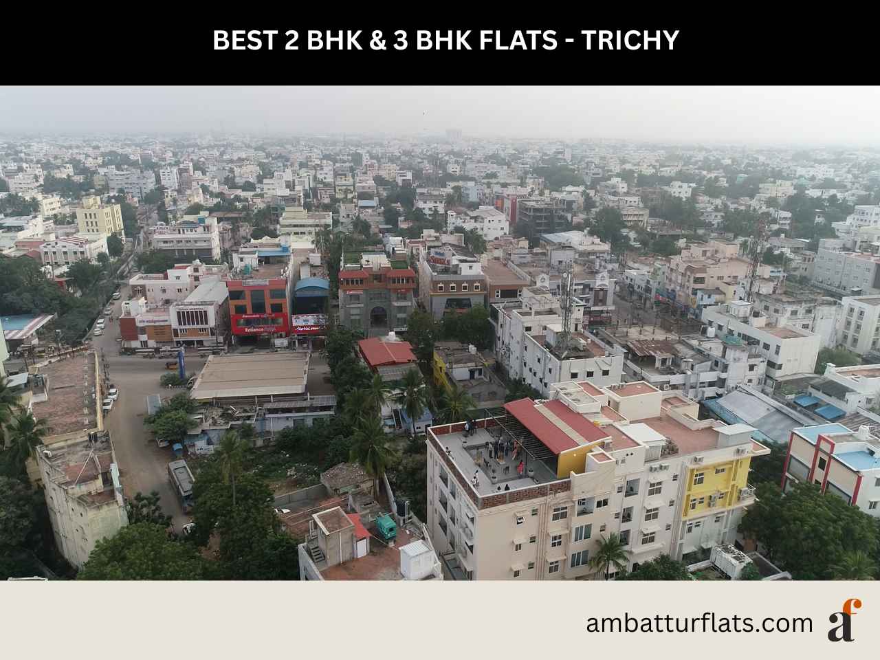 Spacious living room interior of a modern 2 BHK and 3 BHK apartment in Trichy, with the ambatturflats.com logo.