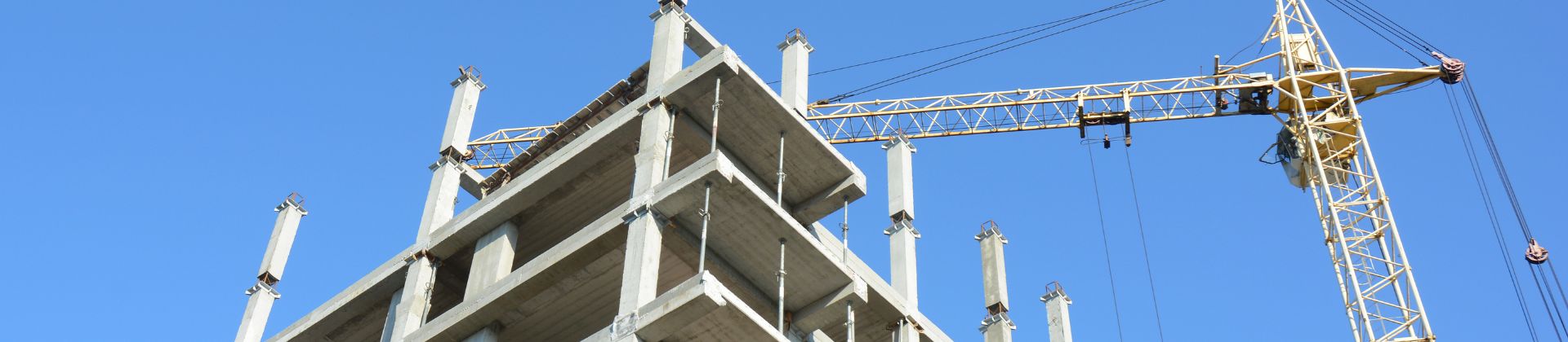 Image of a building under construction. A crane is also seen.