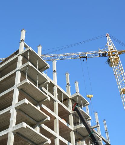 Image of a building under construction. A crane is also seen.