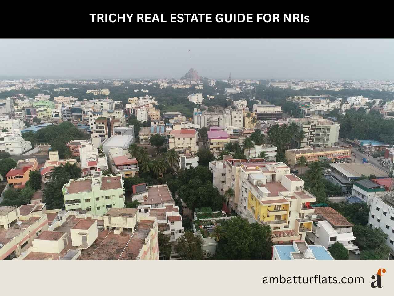 Aerial skyline of Trichy city relevant to NRI real estate investment decisions, with the ambatturflats.com logo.