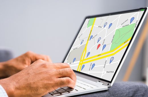 A person viewing a location map on a laptop